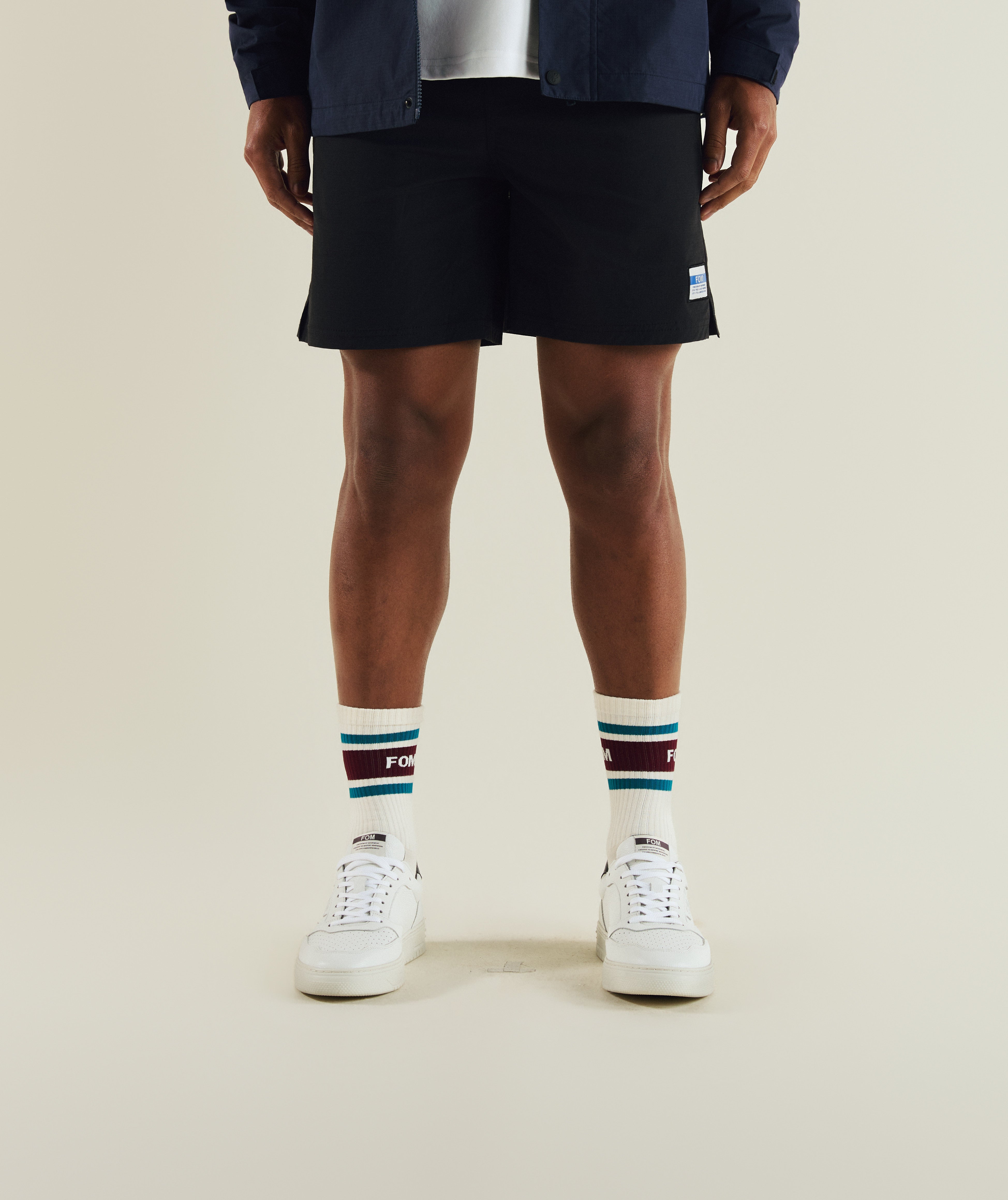 Man wearing FOM FreeMotion micro ripstop shorts in black