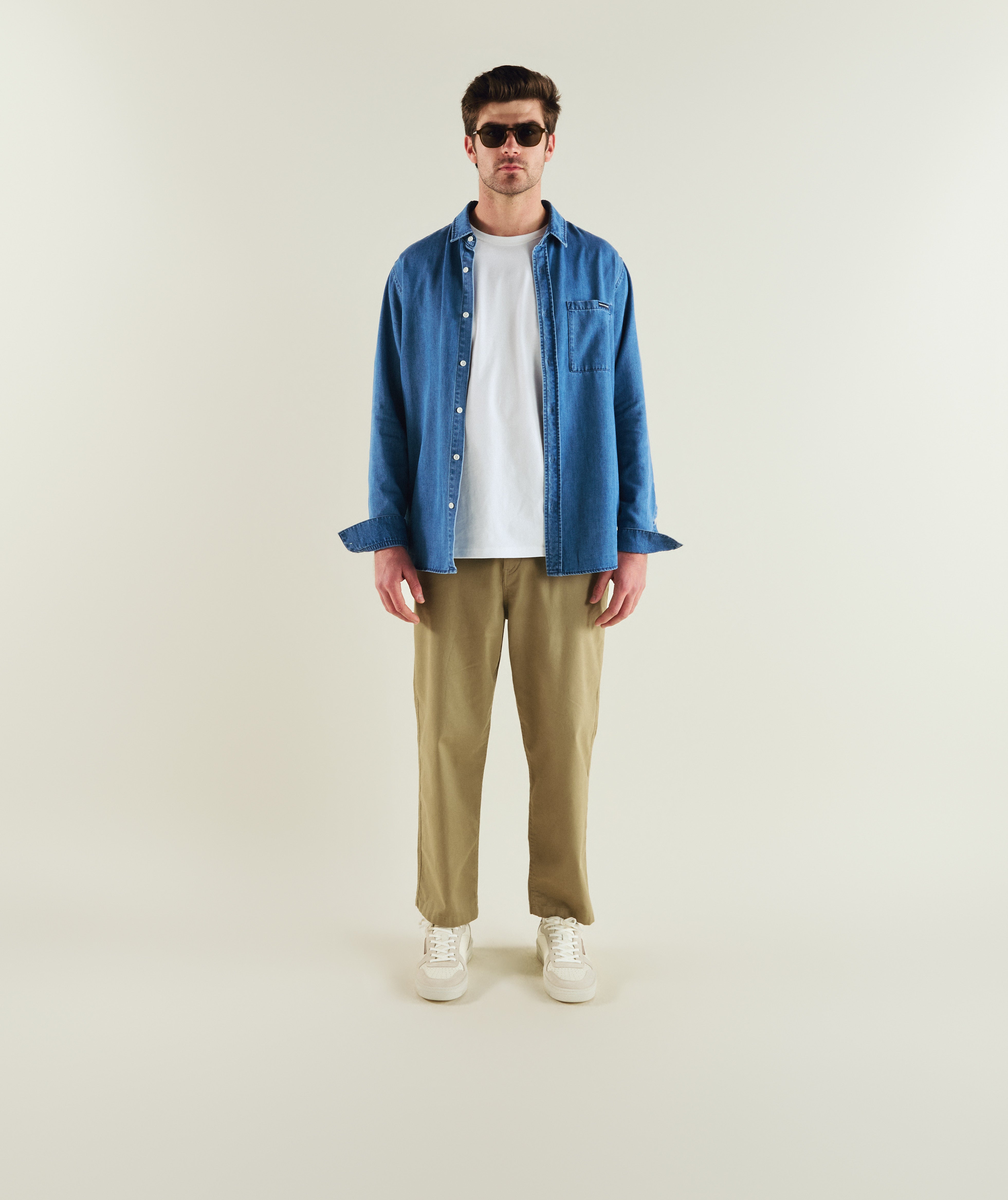 Man wearing FOM long sleeve denim shirt in light wash