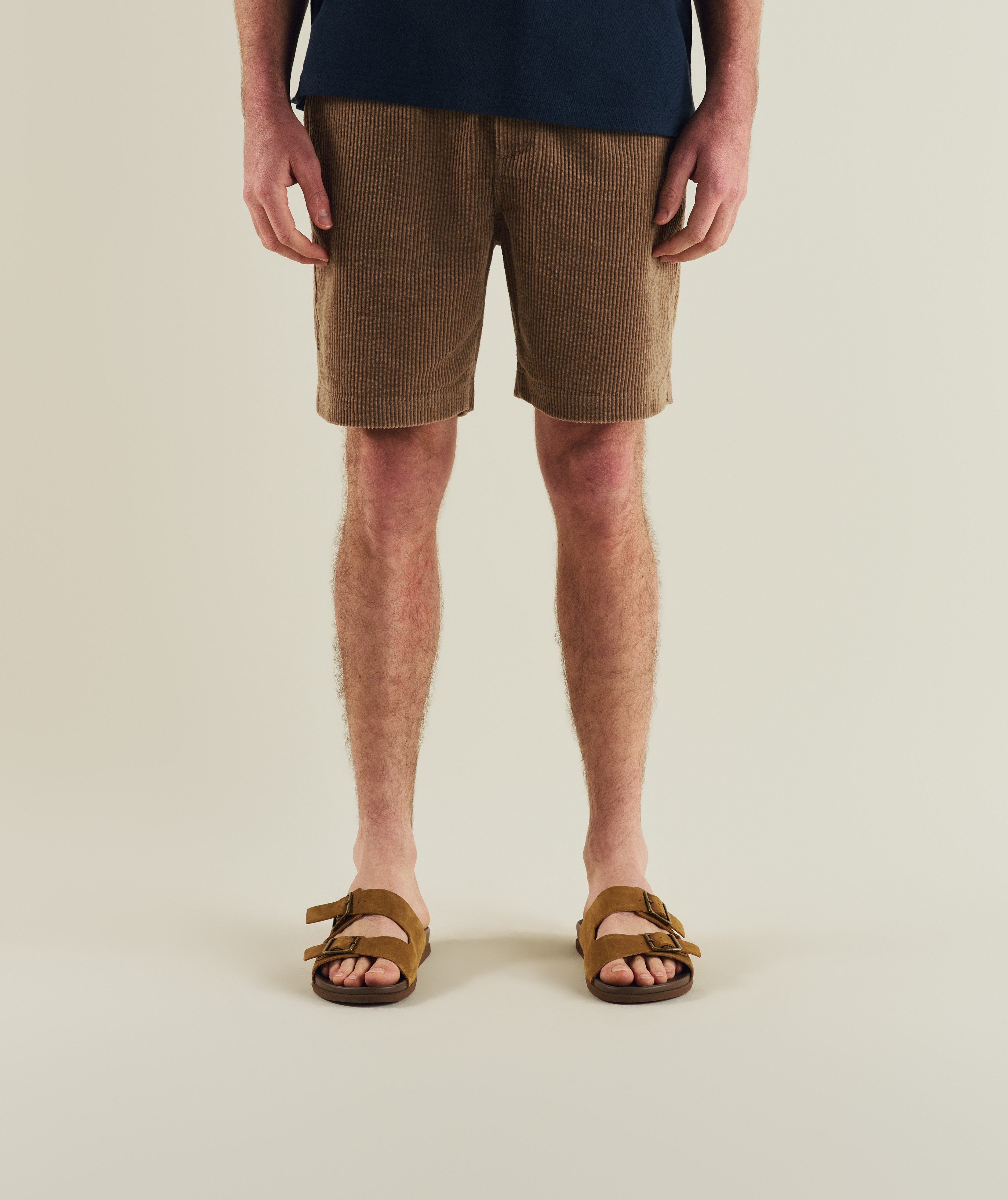 Man wearing FOM corduroy shorts in tahini