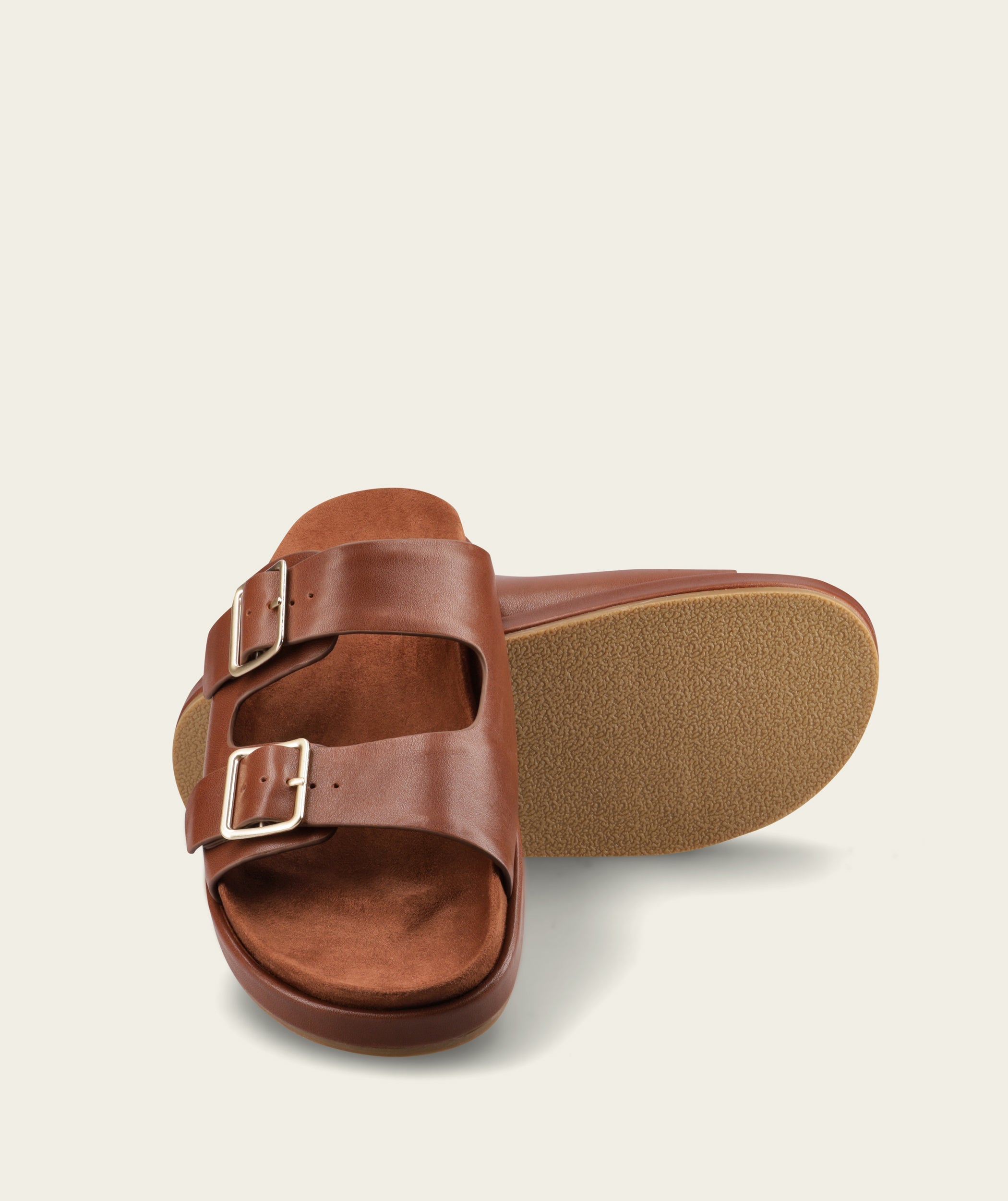 FOM Dani ox choc leather slide sandal, angled view with one sandal turned to show the rubber outsole