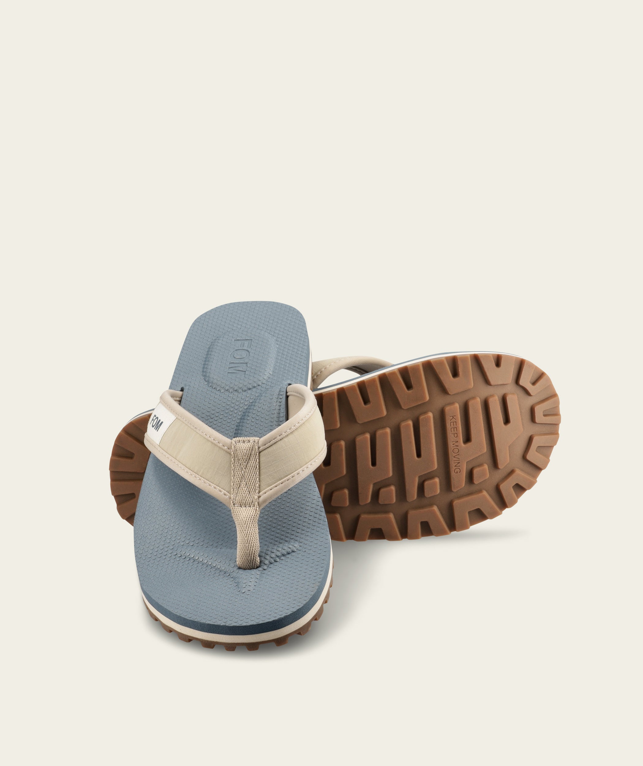 FOM mens adventure flop in sand and ocean, three-quarter view