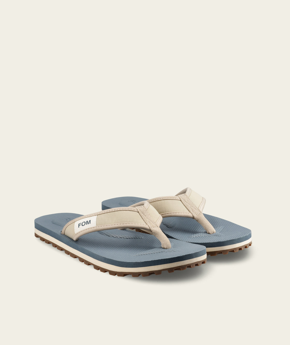 FOM mens adventure flop in sand and ocean, side view