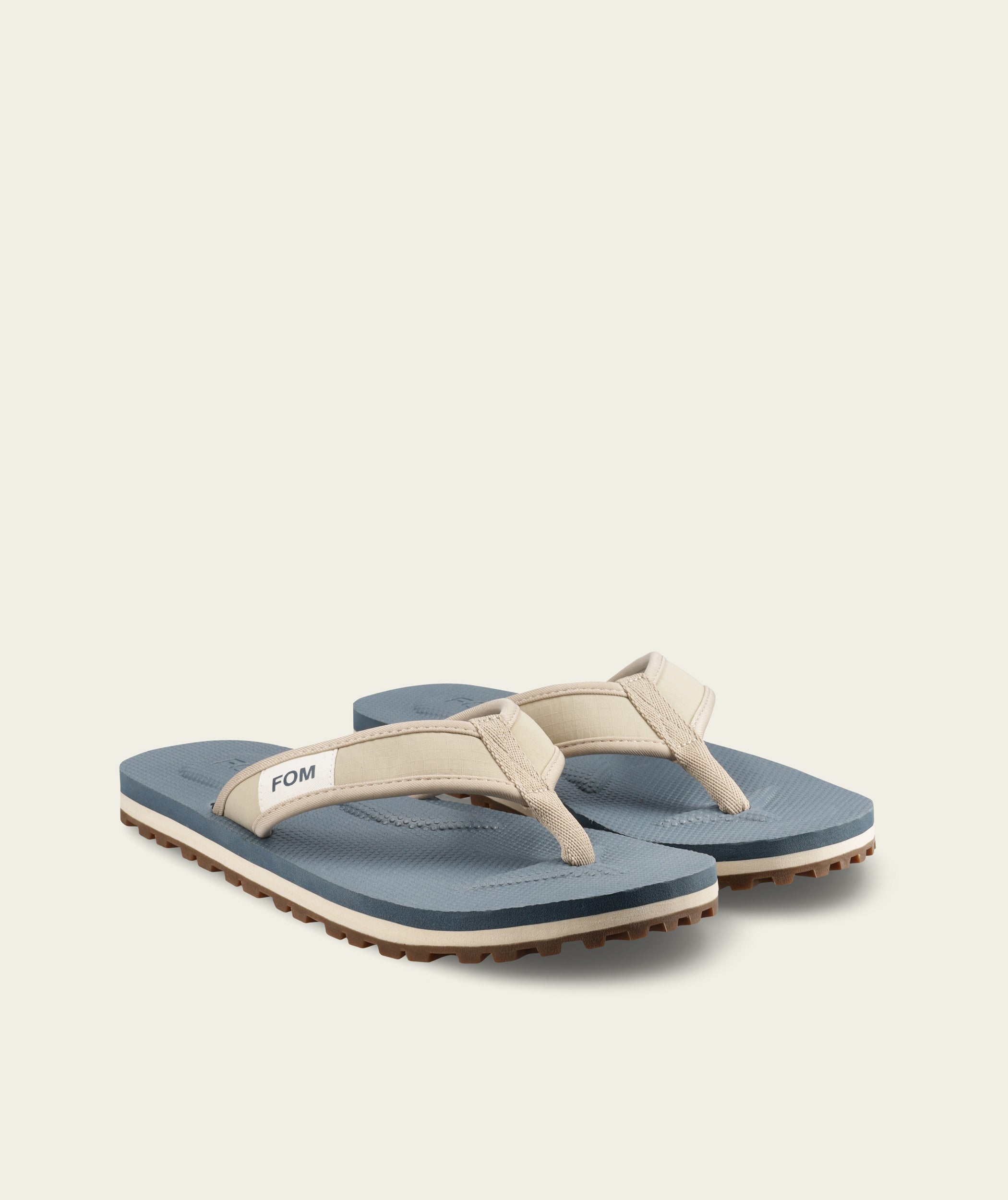 FOM mens adventure flop in sand and ocean, side view