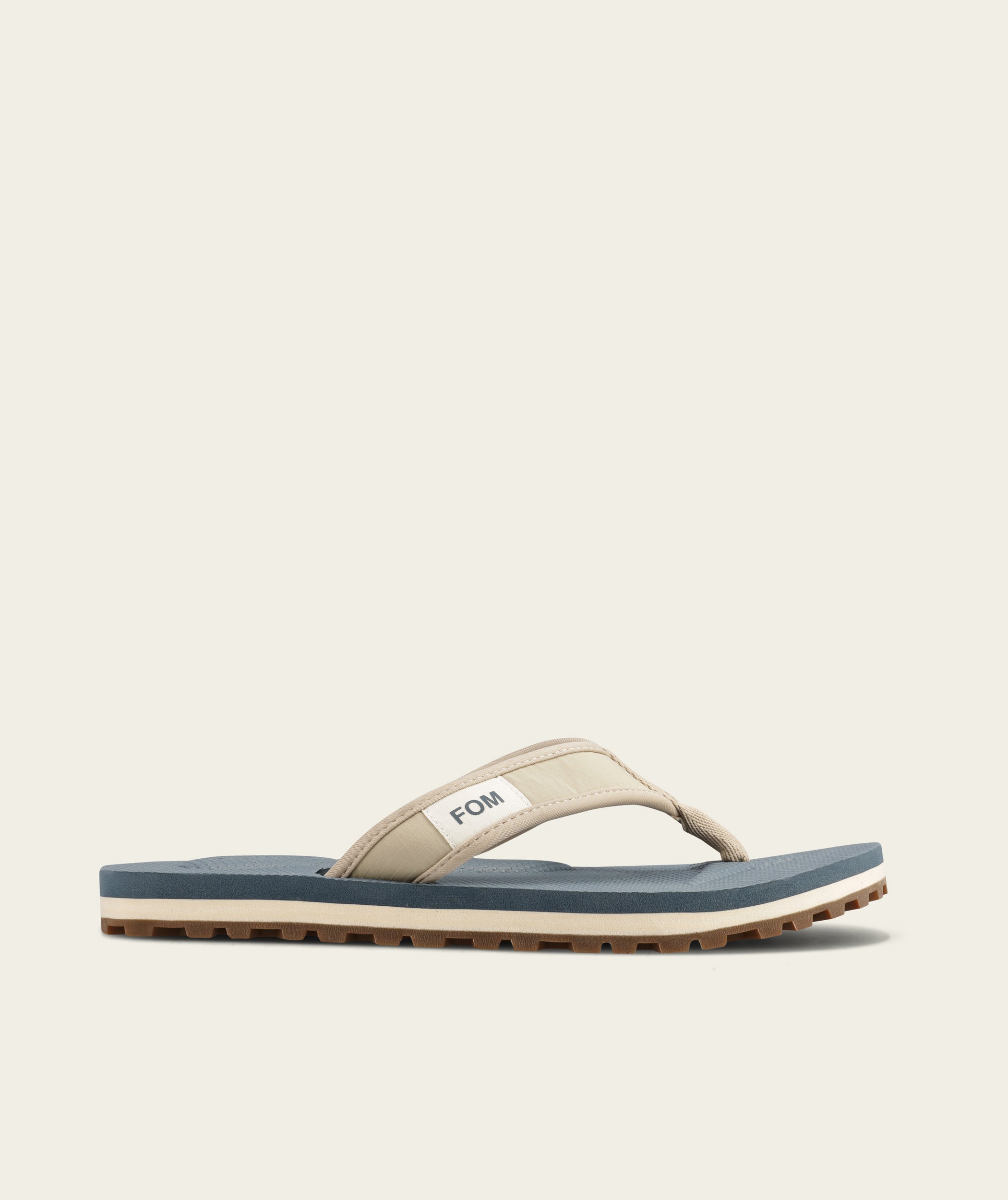 FOM mens adventure flop in sand and ocean, side view